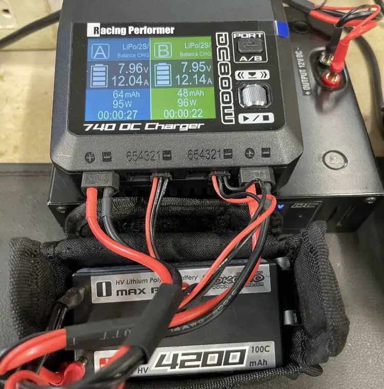LiPo balance charger displaying battery chemistry settings and individual cell voltage readings