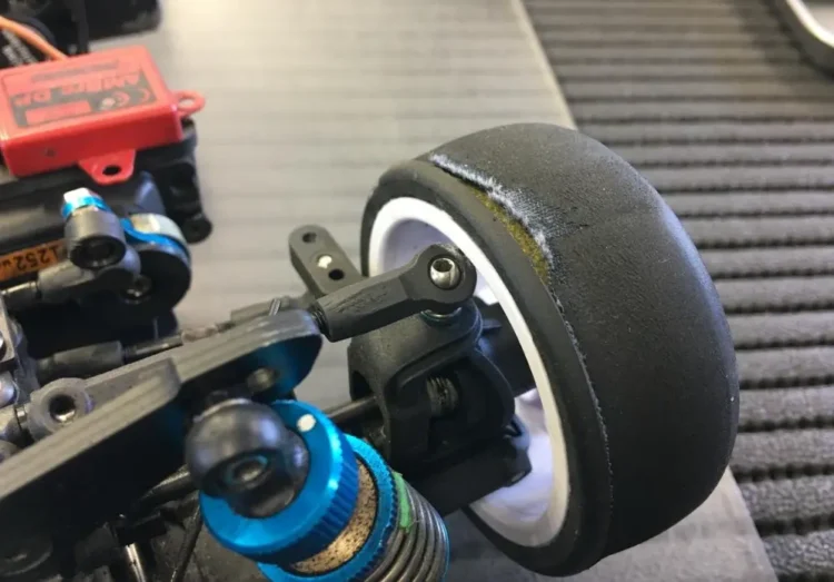 RC car front tire showing uneven wear along the inner shoulder