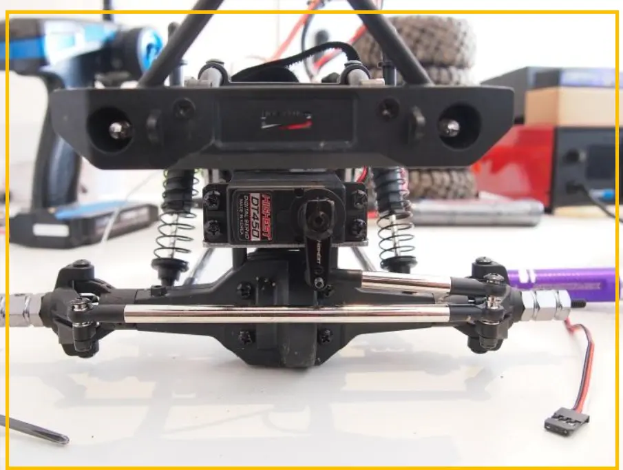 Replacement RC servo prepared for installation in a car chassis