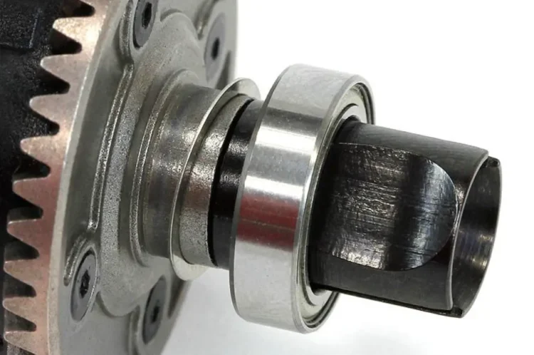 Thin shims positioned beside an RC car differential bearing to adjust gear mesh