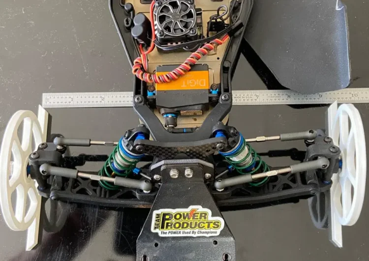 Top view of RC car front wheels showing toe-out alignment