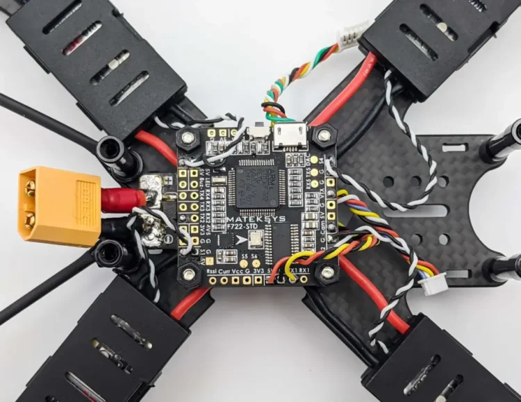 XT60 battery connector and ESC power wire solder joints on an FPV drone